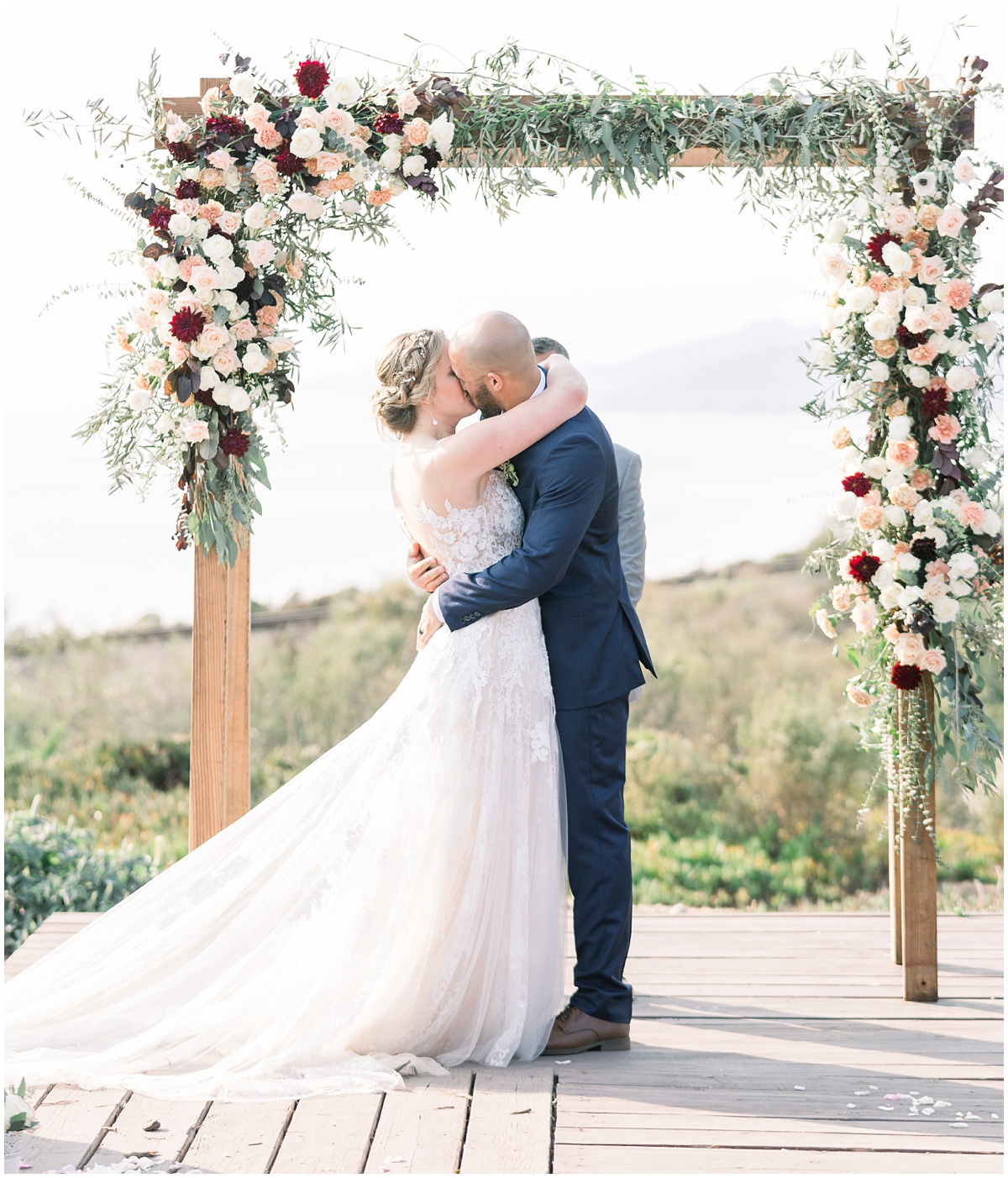 First kiss overlooking the ocean | Dos Pueblos Orchid Farm Wedding in Santa Barbara by Peter and Bridgette
